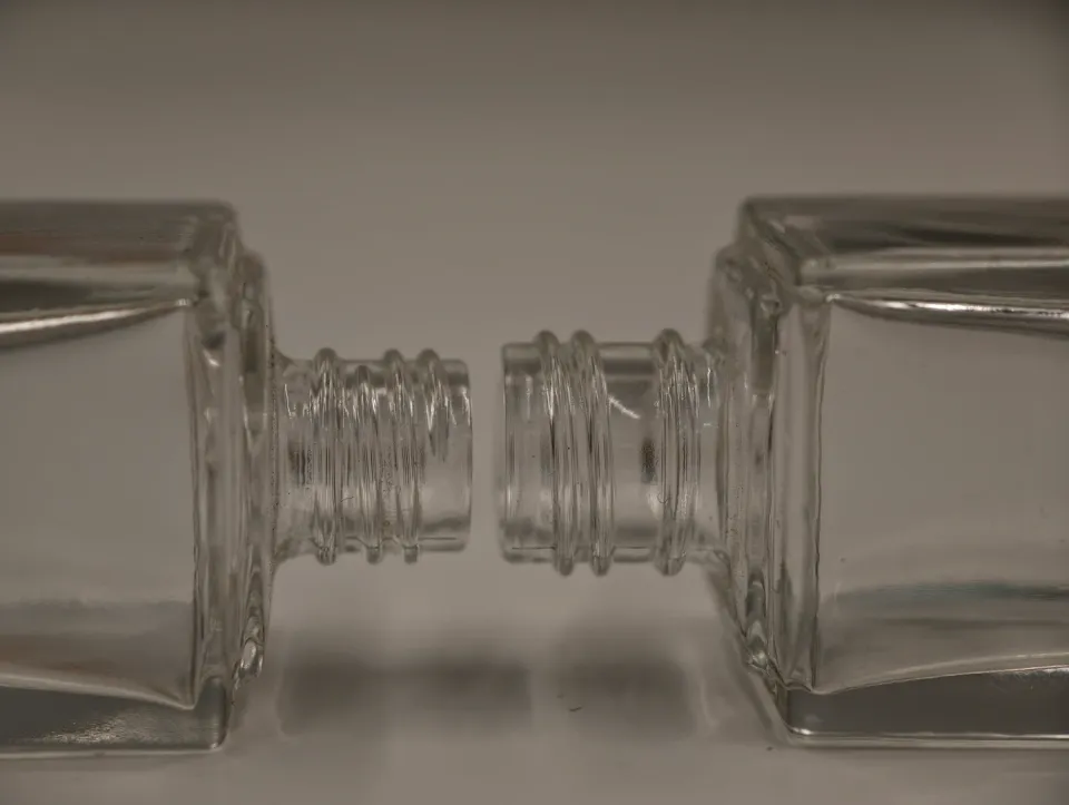 Close-up comparison of two real glass bottle necks